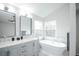 A bathroom features a double vanity, a soaking tub, and modern fixtures at 329 Lodgewood Ln, Lafayette, CO 80026