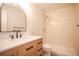 Bathroom featuring new vanity with large mirror and updated shower with modern fixtures at 329 Lodgewood Ln, Lafayette, CO 80026
