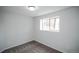 Bedroom featuring neutral carpet, window for natural light, and fresh white paint at 329 Lodgewood Ln, Lafayette, CO 80026