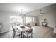 Bright dining area with a modern chandelier and access to the outdoor deck at 329 Lodgewood Ln, Lafayette, CO 80026