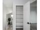 A hallway shows a linen closet with a view of the living room at 329 Lodgewood Ln, Lafayette, CO 80026