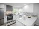 Bright kitchen features white cabinets, stainless steel appliances, and granite countertops at 329 Lodgewood Ln, Lafayette, CO 80026
