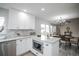Open kitchen flows into dining area, featuring granite counters and stainless appliances at 329 Lodgewood Ln, Lafayette, CO 80026