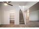 Spacious living room featuring new carpet, stairs to upper level, and open closet with shelving at 329 Lodgewood Ln, Lafayette, CO 80026