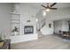 Open-concept living area showcasing a fireplace and views to the kitchen at 329 Lodgewood Ln, Lafayette, CO 80026