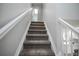 Carpeted stairway leads to the upper level, showcasing the home's layout at 329 Lodgewood Ln, Lafayette, CO 80026