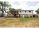 Backyard view of a charming two-story home with a spacious deck and landscaped yard at 12680 W 38Th Dr, Wheat Ridge, CO 80033