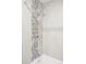 Updated bathroom featuring a shower with modern tile accents and sleek fixtures at 12680 W 38Th Dr, Wheat Ridge, CO 80033