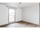 Bedroom with bare walls, wood-look floor and a window, allowing natural light to brighten the space at 12680 W 38Th Dr, Wheat Ridge, CO 80033