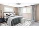 Well-lit bedroom with a comfortable bed, decorative pillows, and soft carpet for a relaxing ambiance at 12680 W 38Th Dr, Wheat Ridge, CO 80033