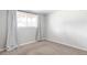 Neutral bedroom with carpet and a window, showcasing natural light and simple design at 12680 W 38Th Dr, Wheat Ridge, CO 80033
