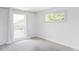 Bright bedroom featuring neutral carpeting, two large windows, and natural light at 12680 W 38Th Dr, Wheat Ridge, CO 80033