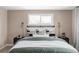 Comfortable bedroom with a padded headboard, two decorative lamps and a large window with natural light at 12680 W 38Th Dr, Wheat Ridge, CO 80033