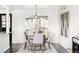 Bright dining room with modern chandelier, stylish furniture, and large windows for natural light at 12680 W 38Th Dr, Wheat Ridge, CO 80033