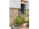 Inviting front entrance with brickwork and flowering bushes leading to a dark front door at 12680 W 38Th Dr, Wheat Ridge, CO 80033