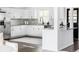Modern kitchen featuring stainless steel appliances, granite countertops, and sleek white cabinetry at 12680 W 38Th Dr, Wheat Ridge, CO 80033
