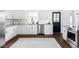 Modern kitchen featuring stainless steel appliances, granite countertops, and sleek white cabinetry at 12680 W 38Th Dr, Wheat Ridge, CO 80033
