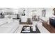 Bright and airy living space featuring a cozy living room connected to a dining area and modern kitchen at 12680 W 38Th Dr, Wheat Ridge, CO 80033