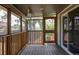 Cozy screened-in porch with wood flooring, offering a relaxing outdoor space at 12680 W 38Th Dr, Wheat Ridge, CO 80033