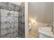 Compact bathroom featuring a tiled shower, toilet, and a sink at 4032 Lipan St, Denver, CO 80211