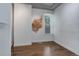 Bedroom featuring hardwood floors, exposed brick, and a window at 4032 Lipan St, Denver, CO 80211