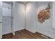 Walk-in closet featuring hardwood floors, exposed brick, and ample shelving at 4032 Lipan St, Denver, CO 80211
