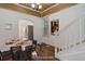Dining room with wood floors, decorative ceiling and an arched doorway to kitchen at 4032 Lipan St, Denver, CO 80211