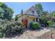 Charming exterior with a decorative brick and wood gate and beautiful landscaping at 4032 Lipan St, Denver, CO 80211