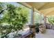 Covered front porch features brick columns and a relaxing space to enjoy the outdoors at 4032 Lipan St, Denver, CO 80211