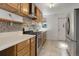 Kitchen with light wood cabinets, mosaic backsplash, and stainless steel appliances at 4032 Lipan St, Denver, CO 80211