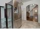 Stainless steel refrigerator and shelving unit in a kitchen with tiled floors at 4032 Lipan St, Denver, CO 80211