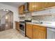 Updated kitchen featuring stainless appliances, light wood cabinets, mosaic backsplash, and views of the dining area at 4032 Lipan St, Denver, CO 80211