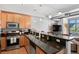 Well-lit kitchen with stainless steel appliances, wooden cabinets, and granite countertops at 3299 Lowell Blvd # 102, Denver, CO 80211
