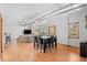 Bright living and dining area with wood floors, industrial-style ductwork, and an open floor plan at 3299 Lowell Blvd # 102, Denver, CO 80211
