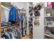 Walk-in closet with custom shelving, hanging rods, and visible clothing and storage at 3299 Lowell Blvd # 102, Denver, CO 80211