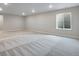 Unfinished basement featuring gray carpet, a window for natural light, and ample space to be designed to your liking at 3443 N Gold Bug Ct, Aurora, CO 80019