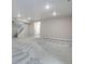 Spacious unfinished basement with plush gray carpeting and access to stairs and a bathroom at 3443 N Gold Bug Ct, Aurora, CO 80019
