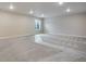 Unfinished basement with plush gray carpeting and a window for natural light, ready for customization at 3443 N Gold Bug Ct, Aurora, CO 80019