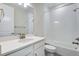 Bright bathroom with a white vanity, toilet, and a shower-tub combo with white tiles at 3443 N Gold Bug Ct, Aurora, CO 80019