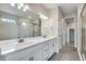 Modern bathroom featuring a double sink vanity with stone countertop and glass enclosed shower at 3443 N Gold Bug Ct, Aurora, CO 80019