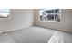 Bedroom with neutral carpet, windows overlooking neighboring homes at 3443 N Gold Bug Ct, Aurora, CO 80019