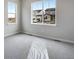 Bedroom with neutral carpet, windows overlooking neighboring homes and landscaping at 3443 N Gold Bug Ct, Aurora, CO 80019