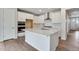 Spacious kitchen featuring stainless steel appliances, white cabinetry, and a functional center island at 3443 N Gold Bug Ct, Aurora, CO 80019