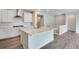 Modern kitchen featuring white cabinetry, stainless steel appliances, and a large center island perfect for cooking at 3443 N Gold Bug Ct, Aurora, CO 80019