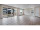 Open living room with hardwood floors, recessed lighting, slider to a patio and bright window views at 3443 N Gold Bug Ct, Aurora, CO 80019