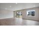 Bright living room featuring hardwood floors, recessed lighting, and large windows with views of the neighborhood at 3443 N Gold Bug Ct, Aurora, CO 80019