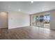 Bright living room featuring hardwood floors, recessed lighting, and large windows with views of the neighborhood at 3443 N Gold Bug Ct, Aurora, CO 80019