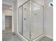 Modern bathroom showcases a glass-enclosed shower with a marble tile surround and tiled flooring at 3443 N Gold Bug Ct, Aurora, CO 80019