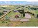 Aerial view of sprawling property with equestrian facilities, including barn, paddocks, and riding arena at 10325 Cherrywood Dr, Parker, CO 80138