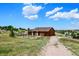 Rustic barn exterior with fenced pen, perfect for equestrian or agricultural pursuits at 10325 Cherrywood Dr, Parker, CO 80138